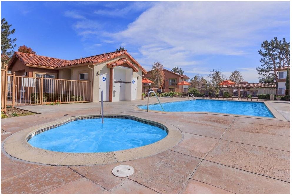 a swimming pool and a spa in front of a house at Riverview Springs, Oceanside, CA,92058