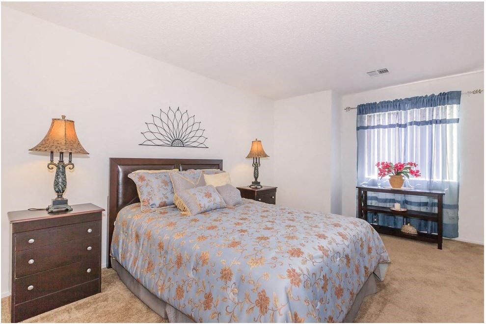a bedroom with a bed and two dressers and a window at Riverview Springs, Oceanside, CA