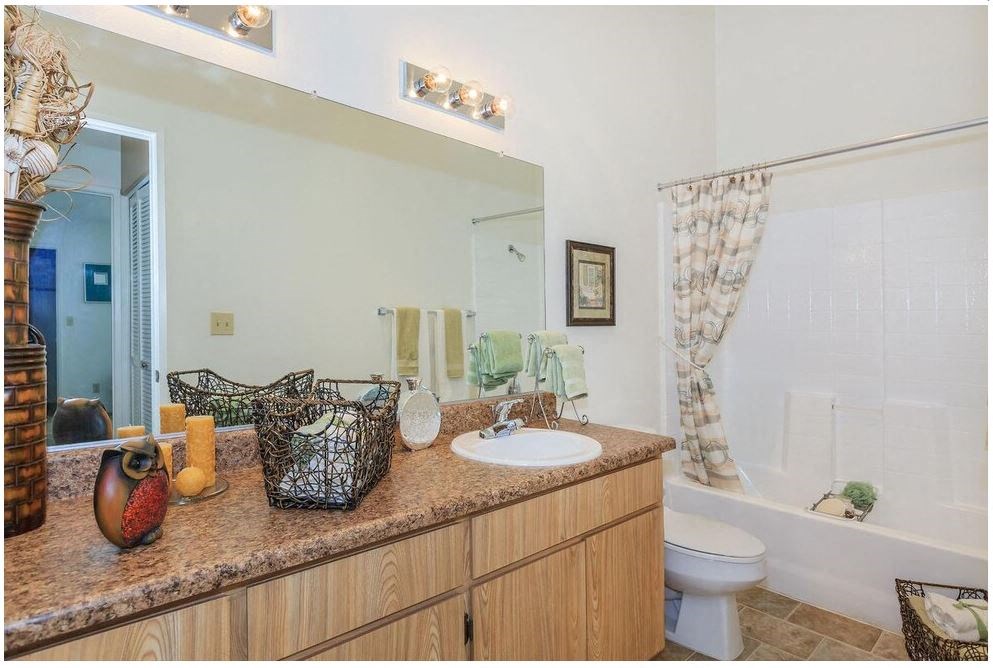 a bathroom with a sink and a toilet and a mirror at Riverview Springs, Oceanside, CA,92058