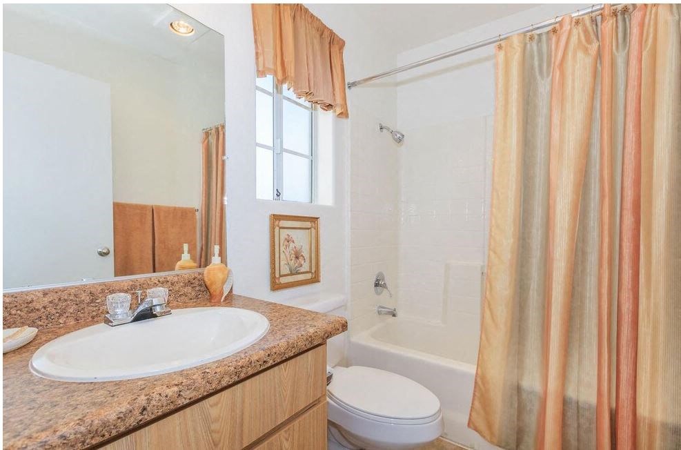 a bathroom with a sink and a toilet and a shower at Riverview Springs, Oceanside, California