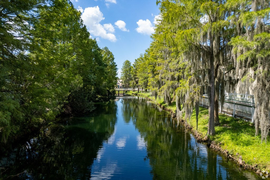 a river with trees on both sides and a bridge over it at Saratoga Resort Villa Apartments, Kissimmee