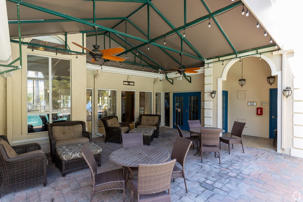 a patio area with tables and chairs at Saratoga Resort Villa Apartments, Kissimmee, FL,  34746