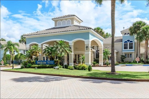 a large house with palm trees in front of it