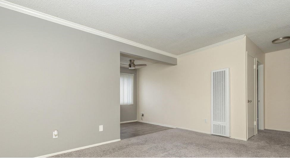 an empty living room with a door to a closet at Villa La Paz Apartments, California