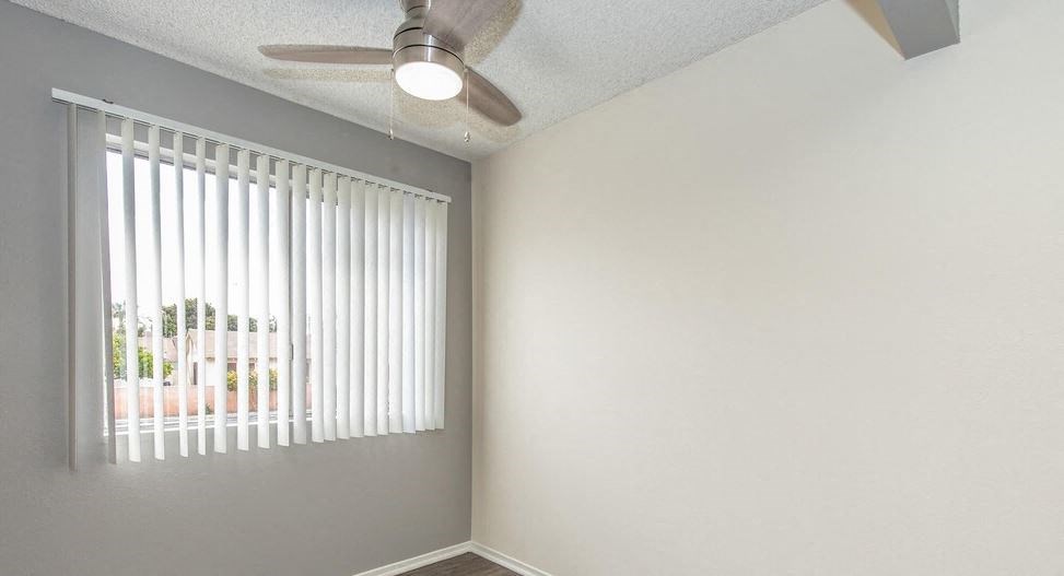an empty room with a window and a ceiling fan at Villa La Paz Apartments, Bellflower, 90706