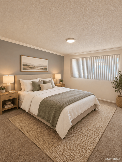 A bedroom with a large bed and a painting on the wall.