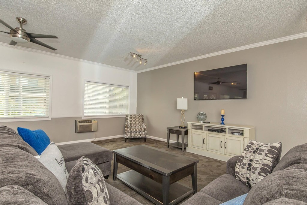 a living room with a couch and a coffee table at Villa La Paz Apartments, California