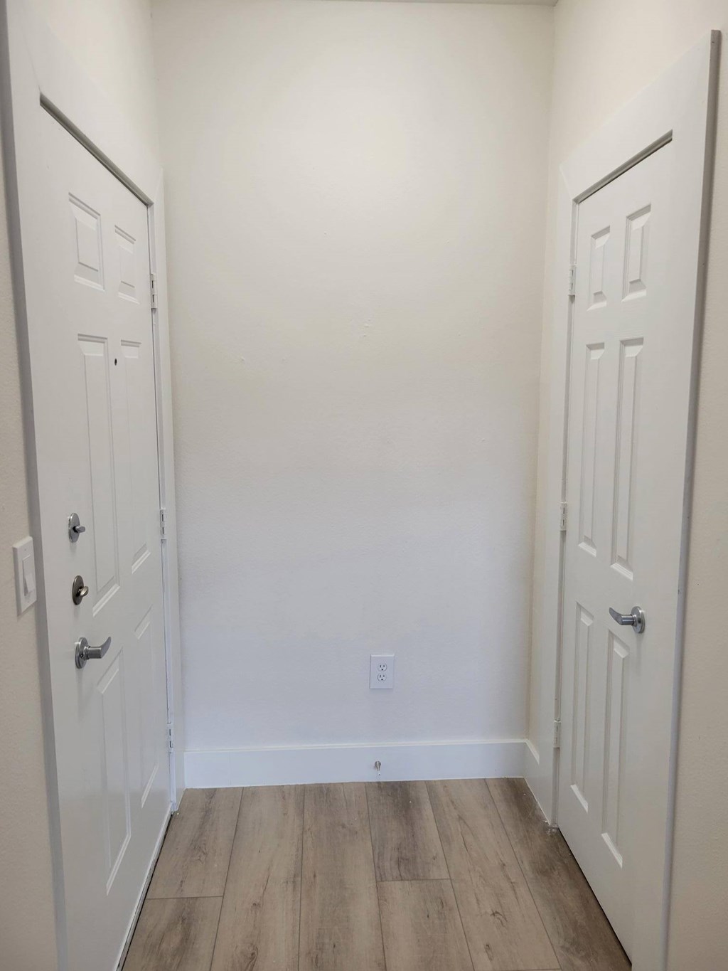 A white door with a silver handle is on the left side of the image.