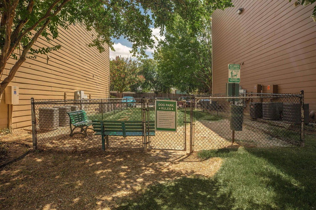 A fenced area with a sign at The Villages at Lost Creek Apartments, San Antonio