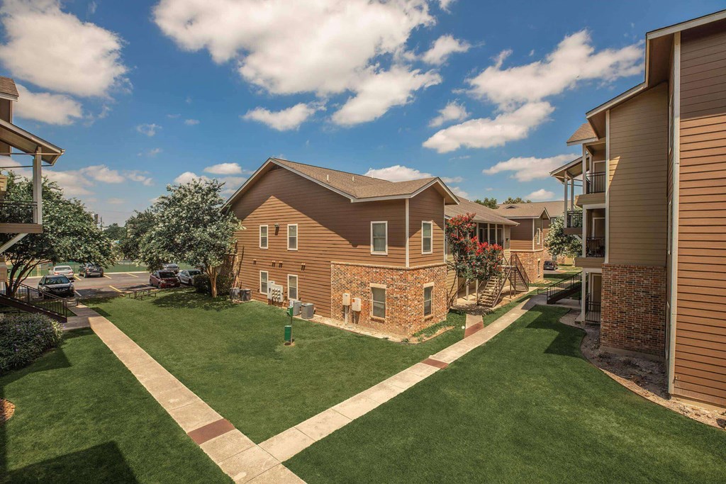 A residential area with houses and green lawns at The Villages at Lost Creek Apartments, San Antonio, TX, 78247