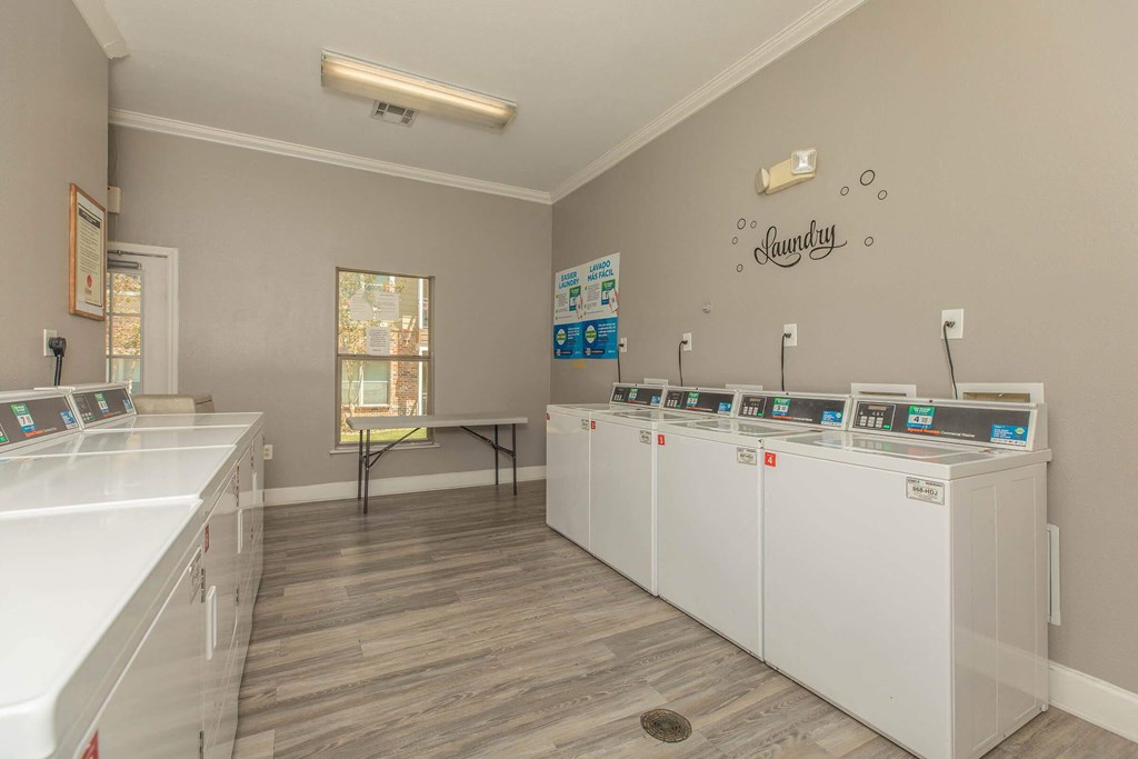 A laundry room with washers and dryers at The Villages at Lost Creek Apartments, Texas