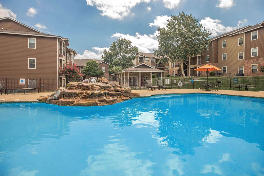 A large swimming pool in front of apartment buildings at The Villages at Lost Creek Apartments, San Antonio, Texas