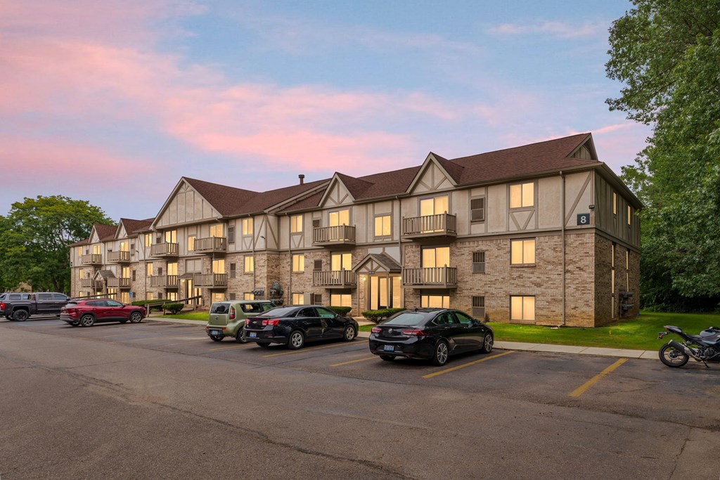 A large building with a parking lot in front of it.
