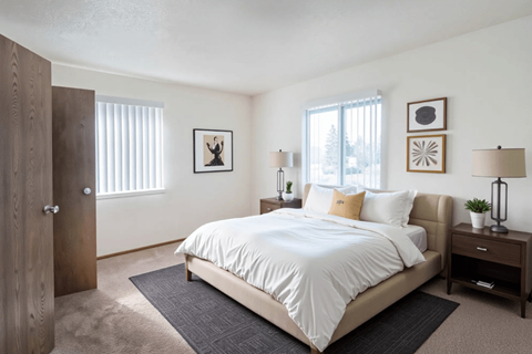 A bedroom with a large bed and a wooden door.