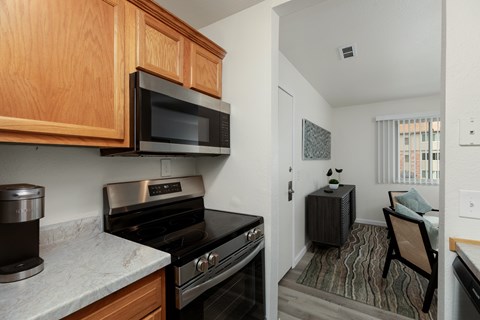 A kitchen with a stove top oven and microwave above it.