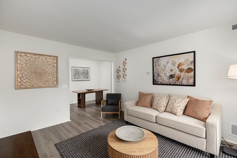 A living room with a white couch and a coffee table.