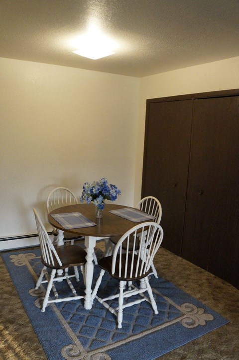 a dining room with a table and chairs