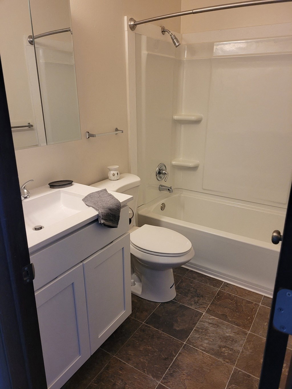 a bathroom with a bathtub toilet sink and mirror