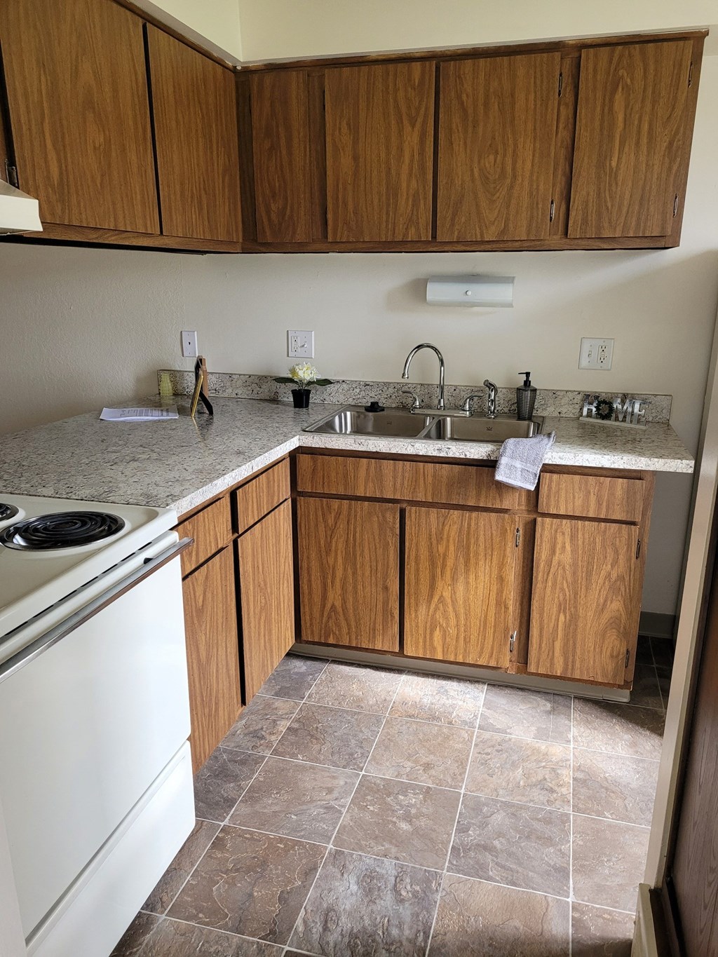 a kitchen with white appliances and wooden cabinets