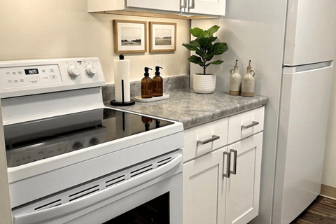 A white stove top oven with a black stovetop.