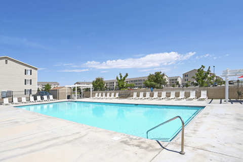 A swimming pool with a blue water and a clear sky.