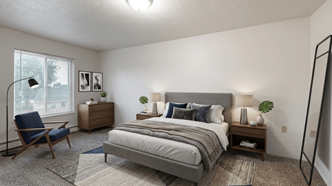 A bedroom with a large bed, a chair, and a nightstand.
