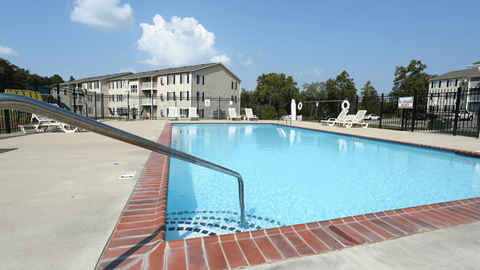 A swimming pool with a red brick border.