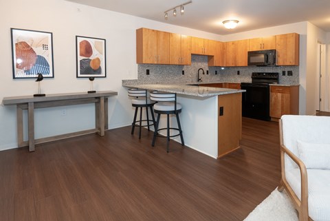 A kitchen with wooden cabinets and a white countertop.