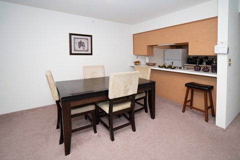a dining room with a table and chairs and a kitchen
