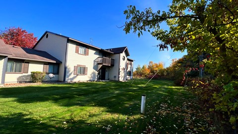 a large house with a yard in front of it