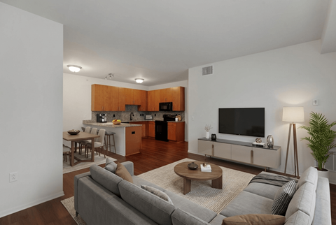 A living room with a grey couch and a wooden coffee table.