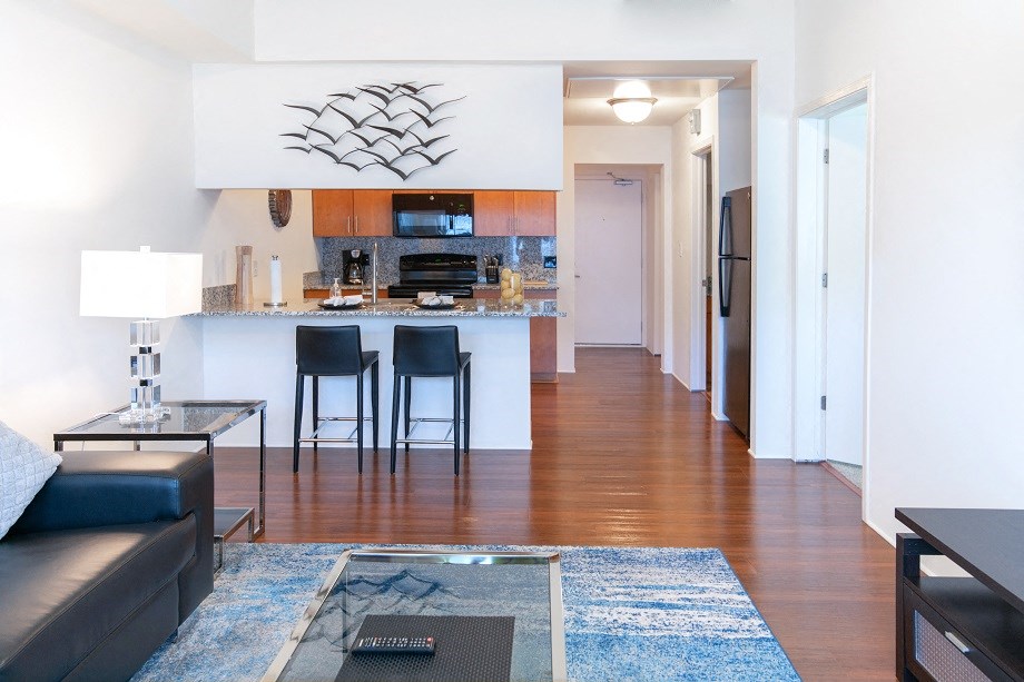 a view of a living room and a kitchen with a bar