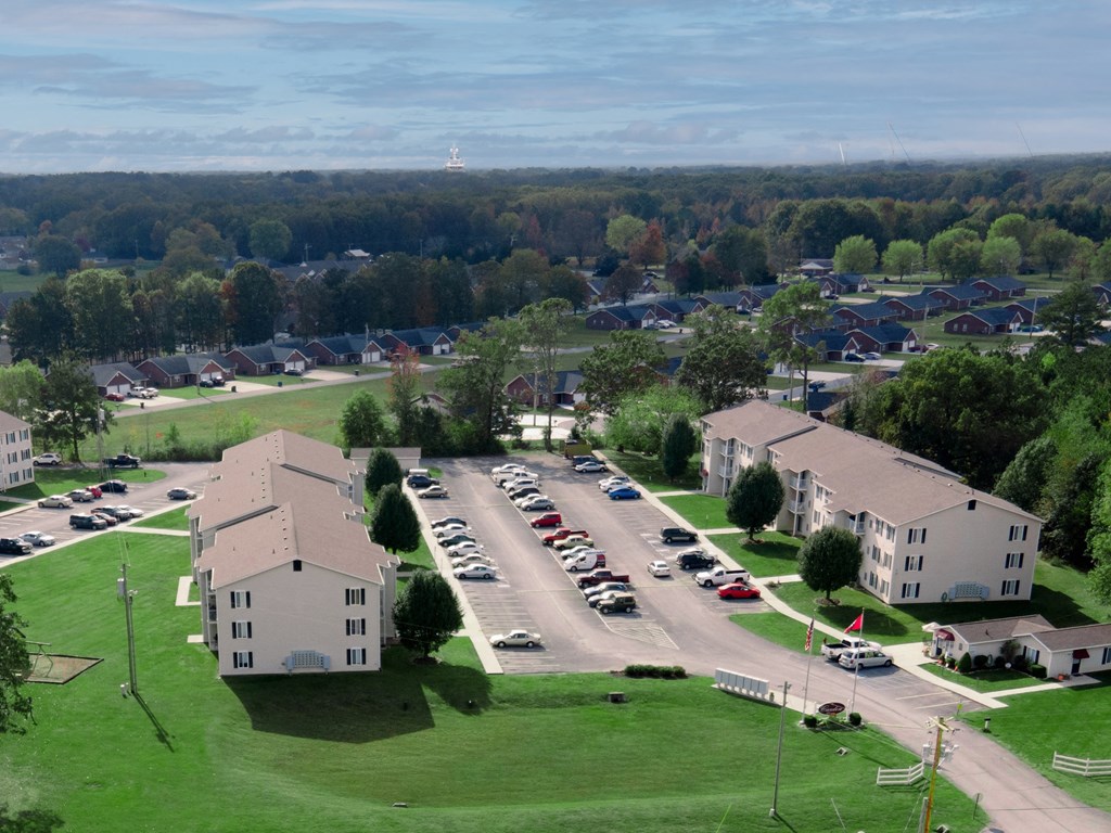 an aerial view of an apartment complex with a parking lot