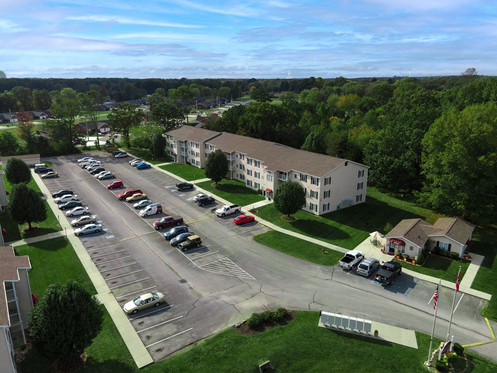 an aerial view of a parking lot and apartment buildings