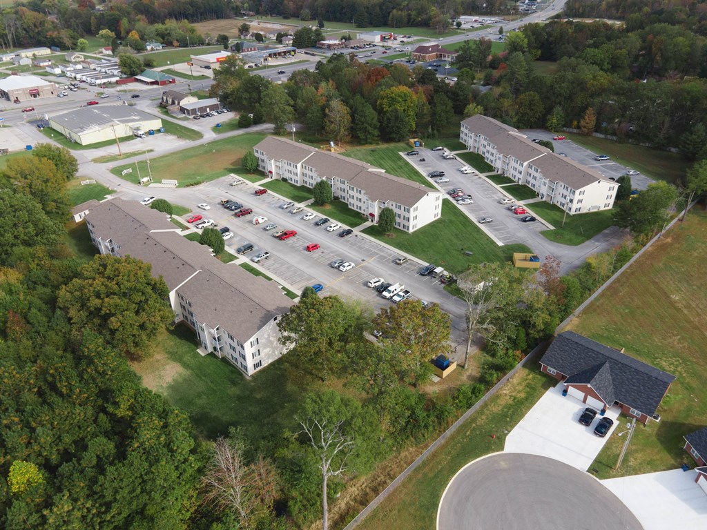 an aerial view of a campus with several buildings and a parking lot