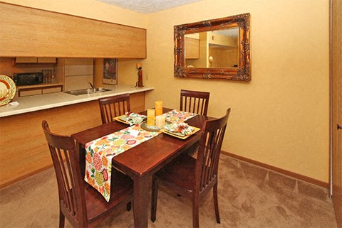 A dining room with a table set for two.