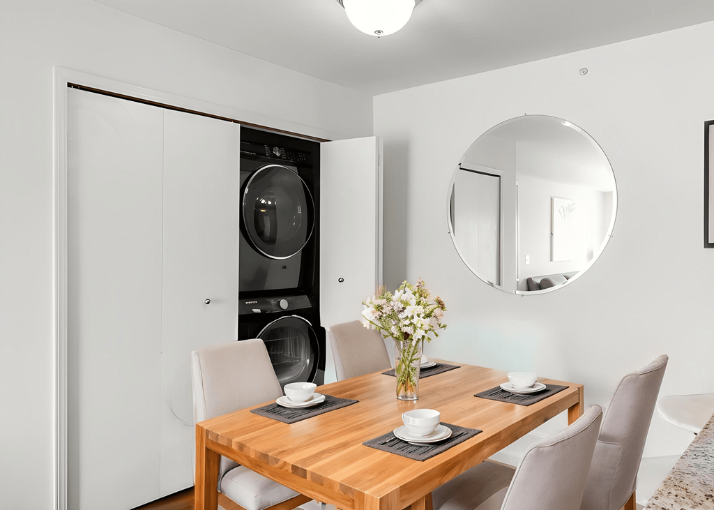 A modern dining room with a wooden table and chairs.
