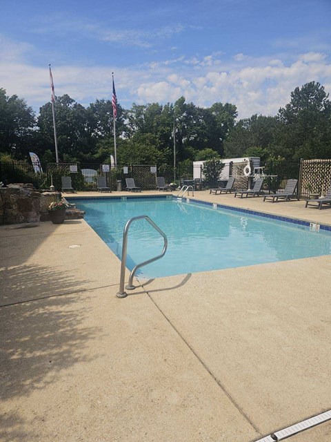 a swimming pool with a railing on the side of it