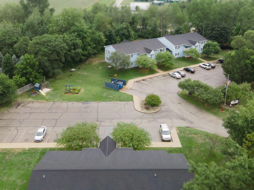 an aerial view of a house and a parking lot