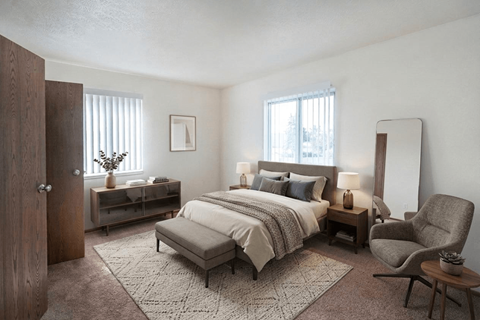 A bedroom with a bed, chair, and nightstands.