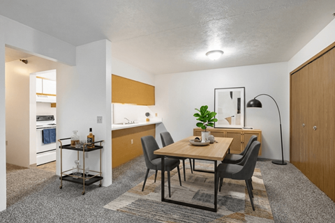 A dining area with a table and chairs.