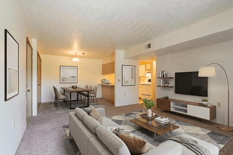 A living room with a grey couch and a coffee table.
