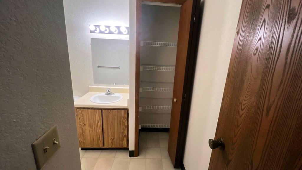 a bathroom with a sink and an open door