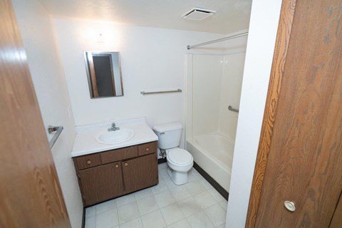 a bathroom with a toilet and a sink and a shower