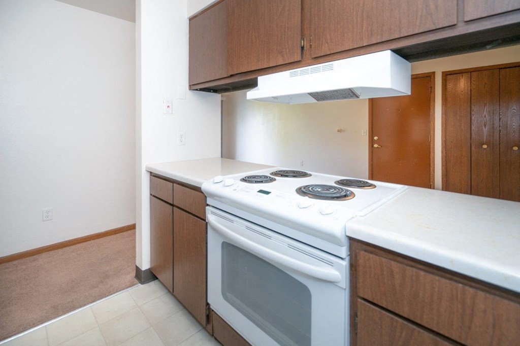 an empty kitchen with an oven and a stove