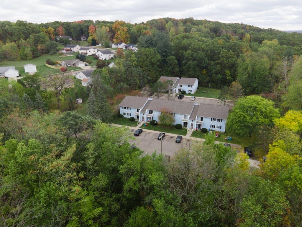 a aerial view of the farmhouse and its neighbors