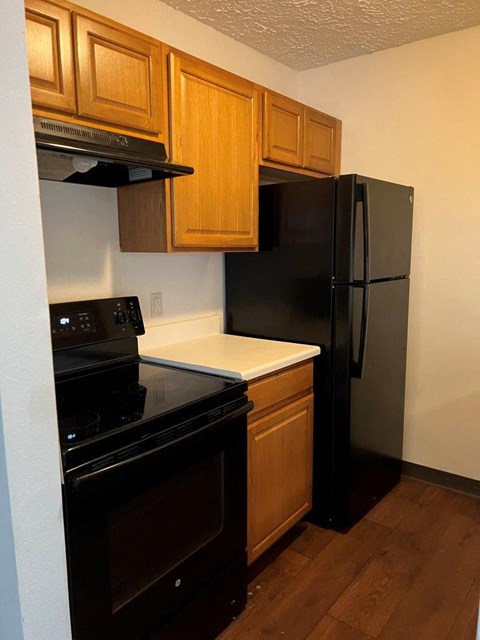 a kitchen with a stove and a refrigerator