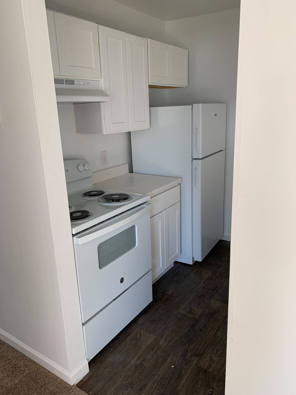 a kitchen with a stove and a refrigerator