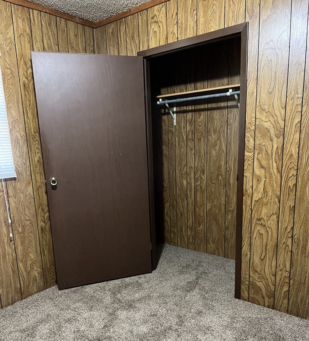 the door to the closet is open in a closet