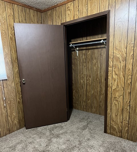 the door to the closet is open in a closet